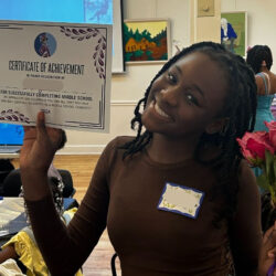 Middle School graduate holding certificate of completion