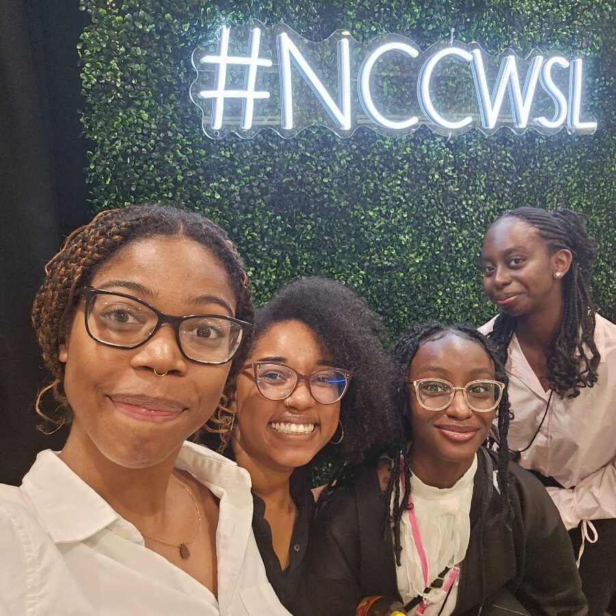 Three participants and staff mentor at NCCWSL event